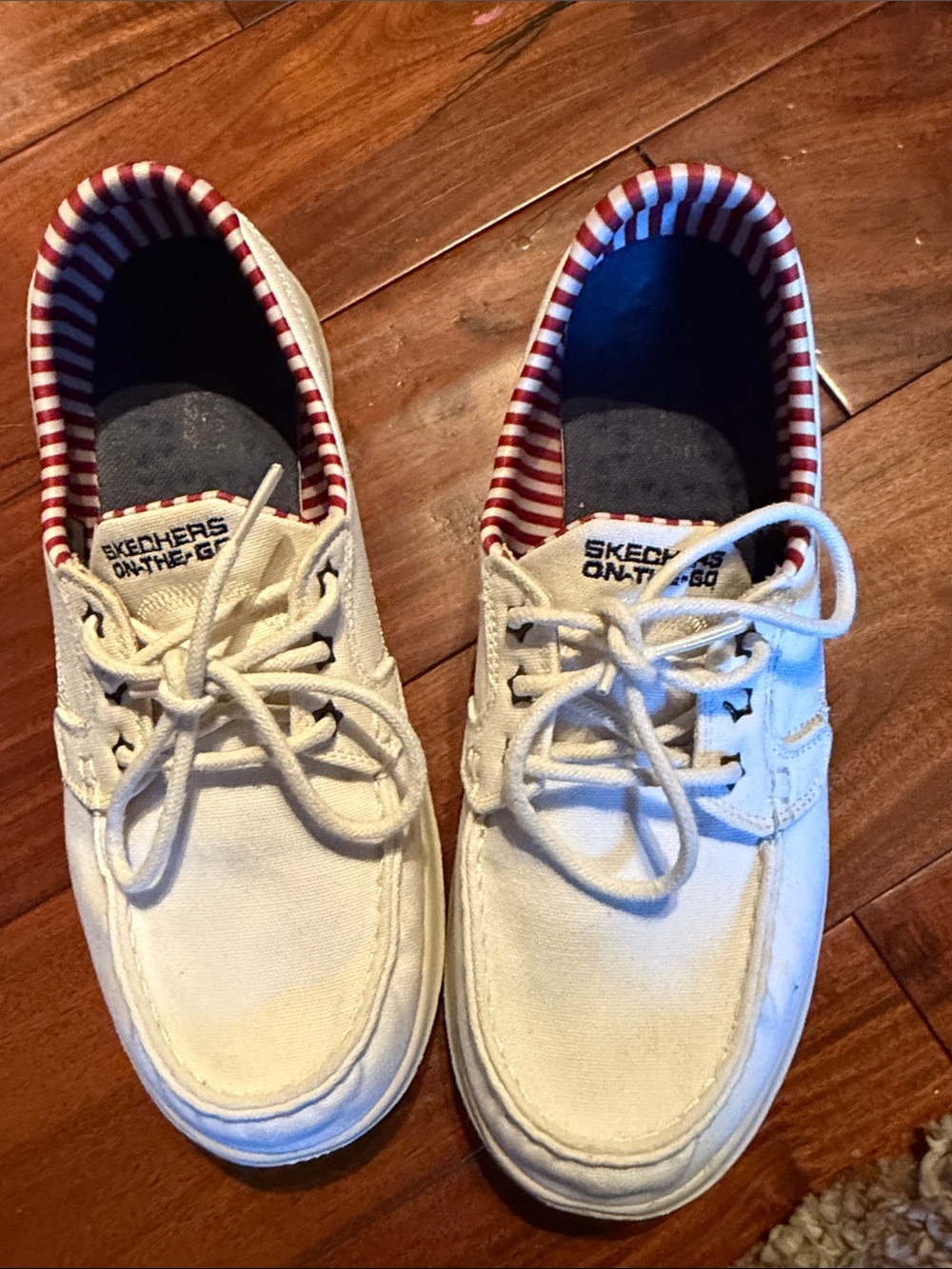 Skechers women’s off White Canvas Lace-Up Sneakers with Red Stripe Lining